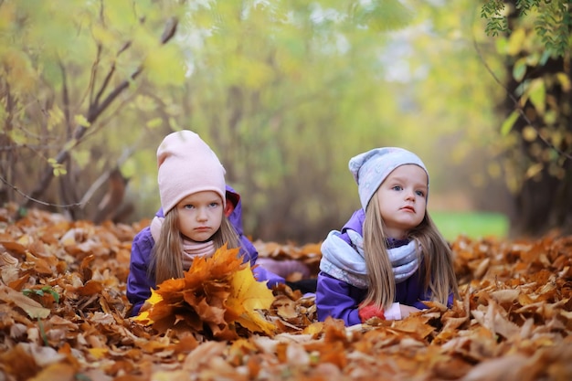 Young family on a walk in the autumn park on a sunny day Happiness to be together