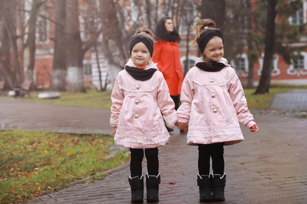 Young family on a walk in the autumn park on a sunny day Happiness to be together