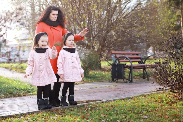 Young family on a walk in the autumn park on a sunny day Happiness to be together