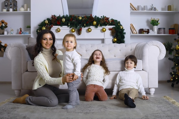 A young family with children decorates the house for the holiday New Years Eve Waiting for the new year