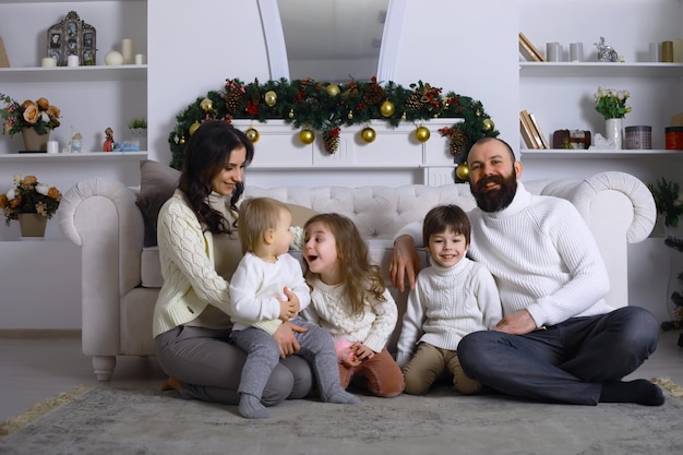 A young family with children decorates the house for the holiday New Years Eve Waiting for the new year