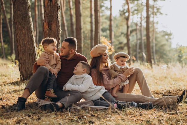 Young family with children having picnic in park