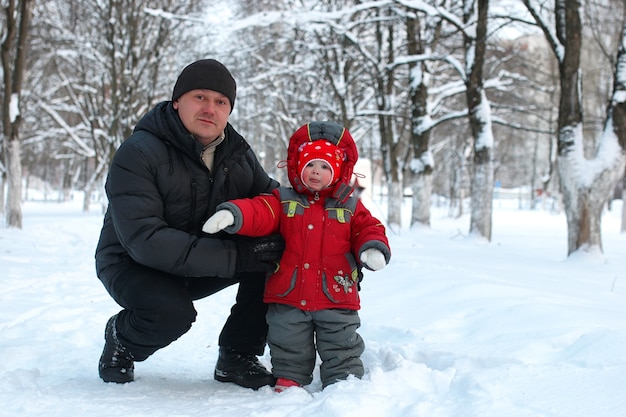 Young family with children on a walk in the park in winter