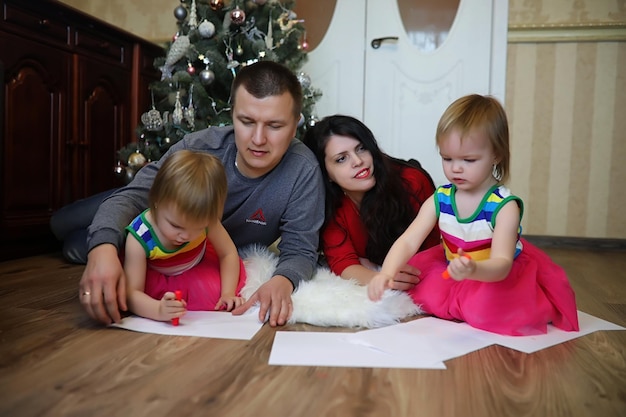 Young family with twin girls in New Year's holidays