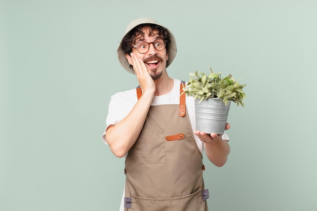 Photo young farmer man feeling happy, excited and surprised