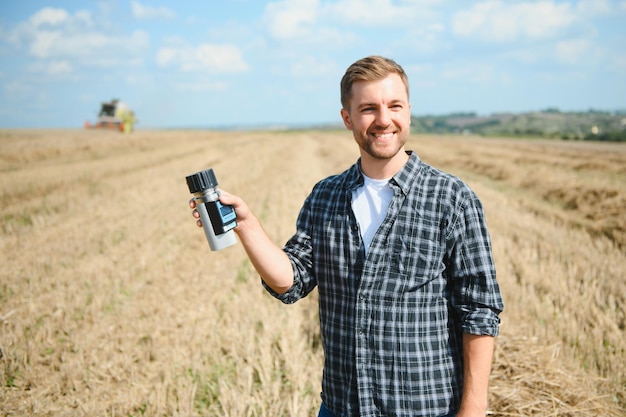 Young farmer in wheat field during harvest in summer