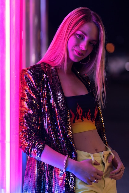 Young fashion woman having fun at luna park at night