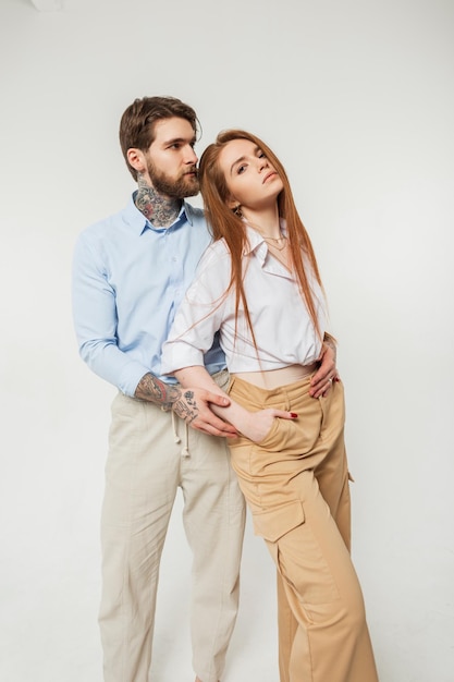 Young fashionable couple on white background