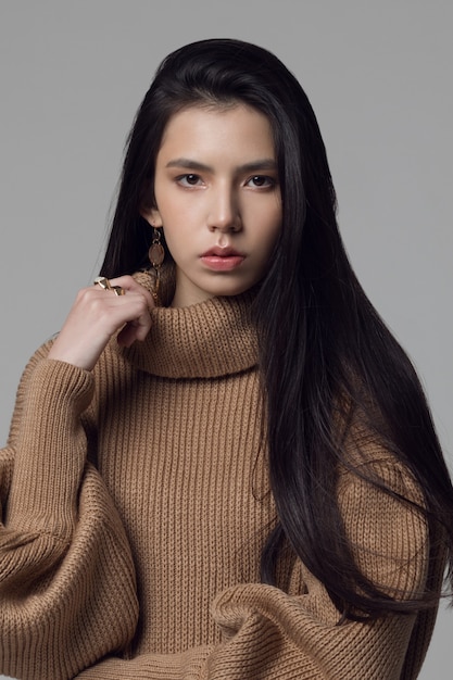 Young fashionable girl of asian appearance, portrait of a brunette girl with brown eyes