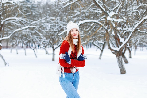 Young fashionable girl in a warm vintage winter clothes in winter snowy day