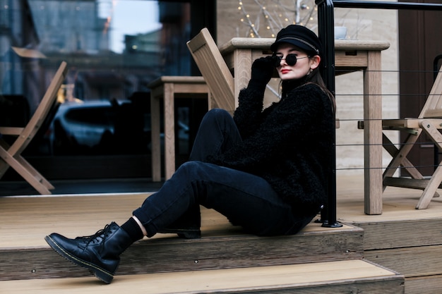 Young fashionable woman with sunglasses and hat