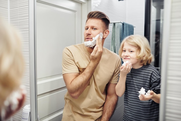 Young Father and Son Shaving