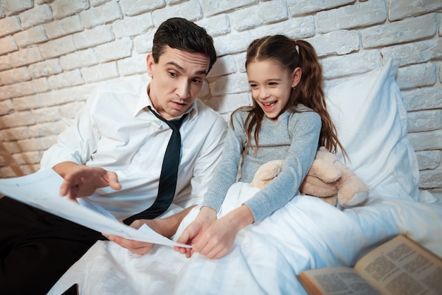 Young father tells his daughter about his work.