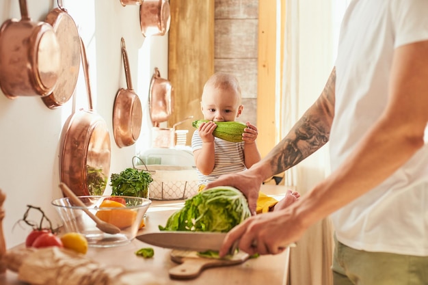 Young father with a toddler boy cooking