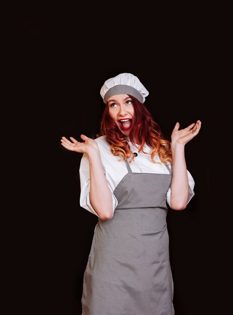 Young female chef with gray apron