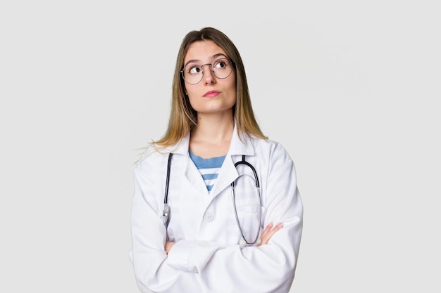 Young female doctor confidently gazing at the camera