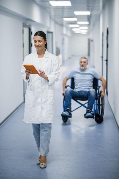 Young female doctor with a tablet in a rehabilitation center