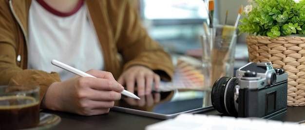 Young female drawing on tablet