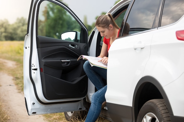 Young female driver got lost and looking for the route in map