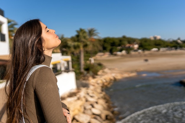 Young female enjoying sunlight on beach