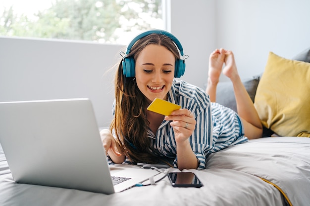 young female freelancer working on laptop She is creating content with camera and working on laptop