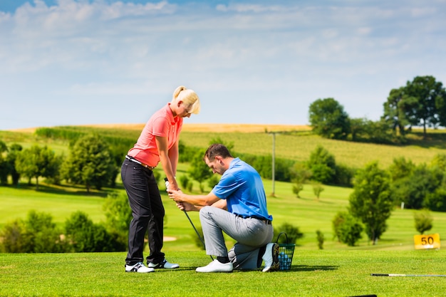 Young female golf player on course