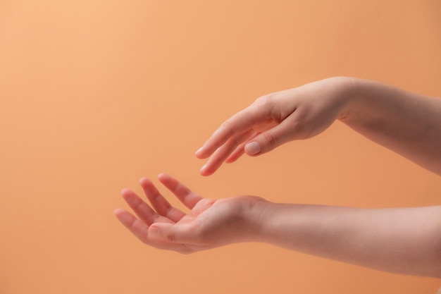 Young female hands applying cream or lotion