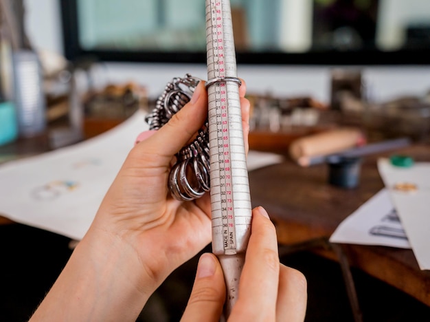 Young female jeweler making jewelry in workshop