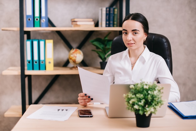 Young female looking at camera in office