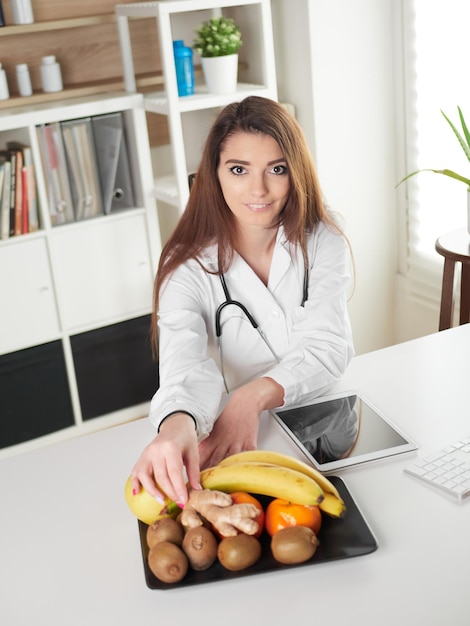 Young female nutritionist in office