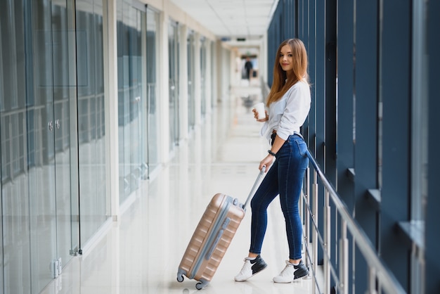 Young, female passenger at the airport, waiting desperately for her delayed flight