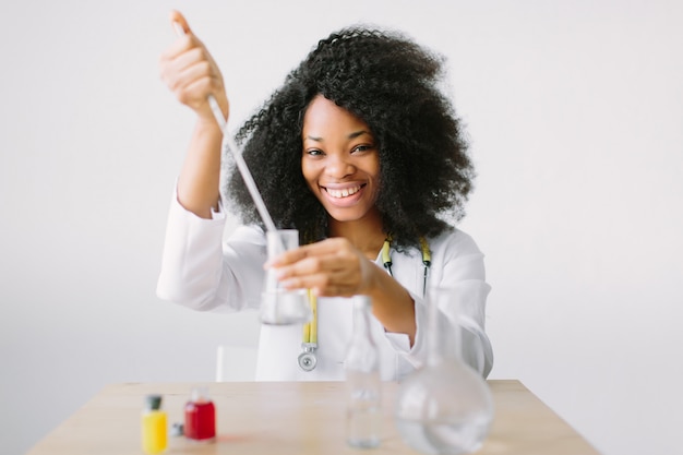 Young Female Scientist Analyzing Sample In Laboratory.laboratory assistant analyzing a sample.