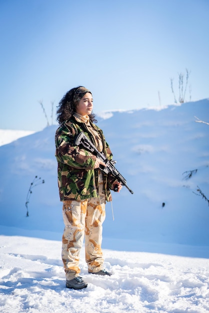 Young Female Soldier In Military Uniform On Winter Snow. High quality photo