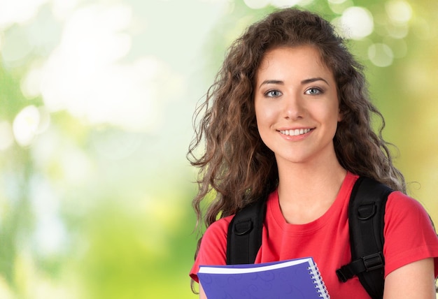 Young female student  on background