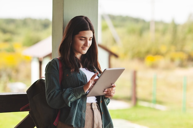 Young female student studying using tablet