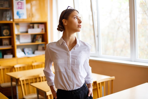 Young female student in white shirt in school class youth education