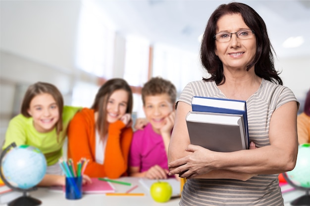 Young female teacher with students in classroom