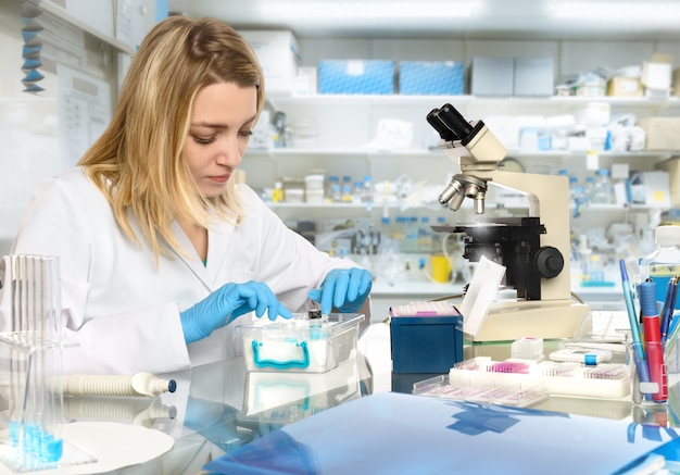 Young female tech or scientist works in research facility