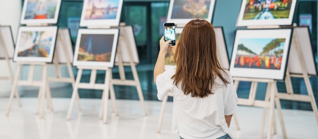 Young female tourist looking gallery exhibition Art photography and museum concept