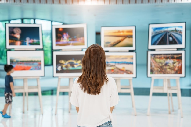 Young female tourist looking gallery exhibition Art photography and museum concept