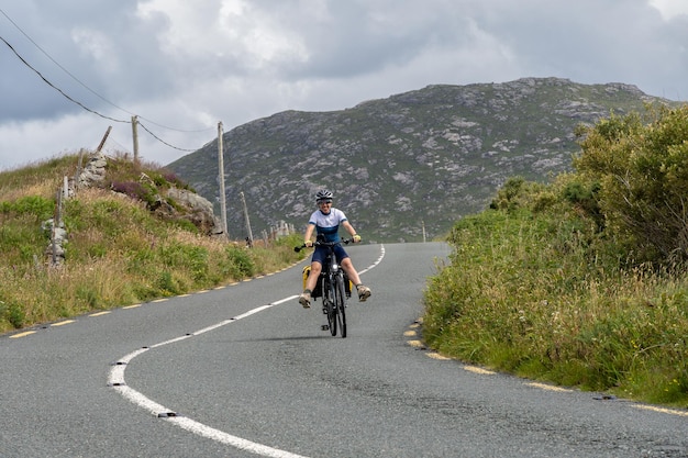 Young female traveler cyclist smiling on Connemara route Galway Ireland