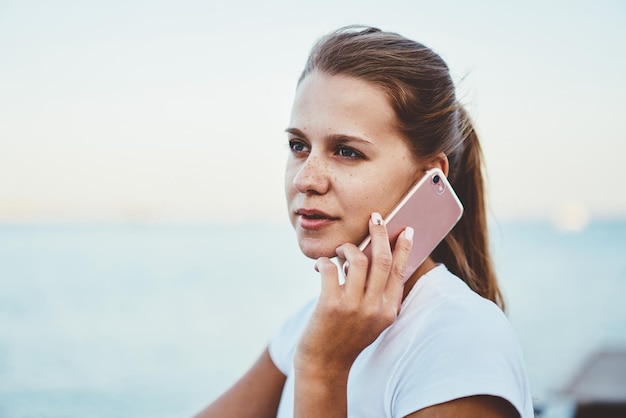 young female without makeup talking on modern smartphone with 4g internet attractive woman calling