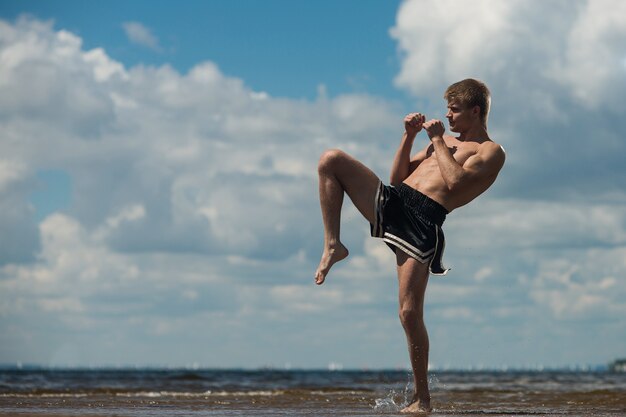 Young fighter kicking, Exercise in the open air, Knee kick