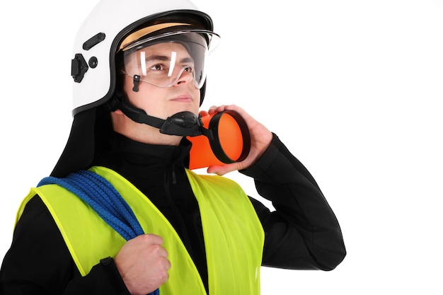 a young firefighter in a white helmet looking against white