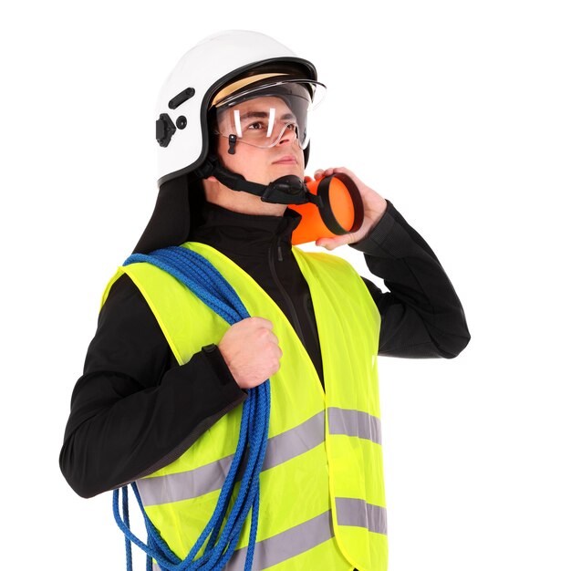 a young firefighter in a white helmet looking against white