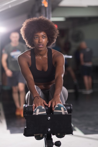 young fit african american woman doing sit ups in fitness studio at the gym.Abdominal exercises Sit up