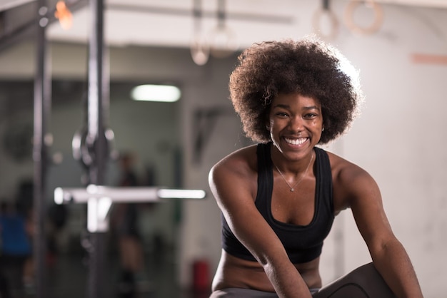 young fit african american woman doing sit ups in fitness studio at the gym.Abdominal exercises Sit up