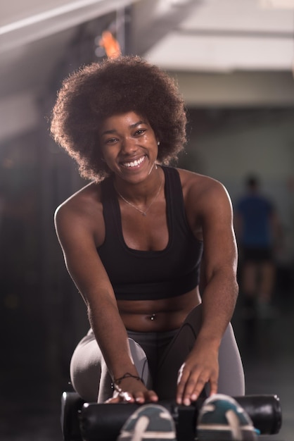 young fit african american woman doing sit ups in fitness studio at the gym.Abdominal exercises Sit up