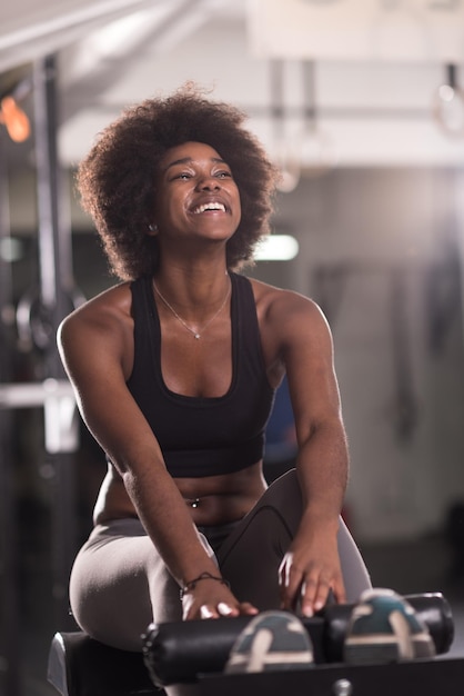 young fit african american woman doing sit ups in fitness studio at the gym.Abdominal exercises Sit up