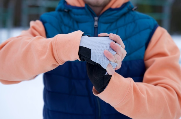 Young fit man is training workout outdoors at winter cold snowy day healthy fitness lifestyle